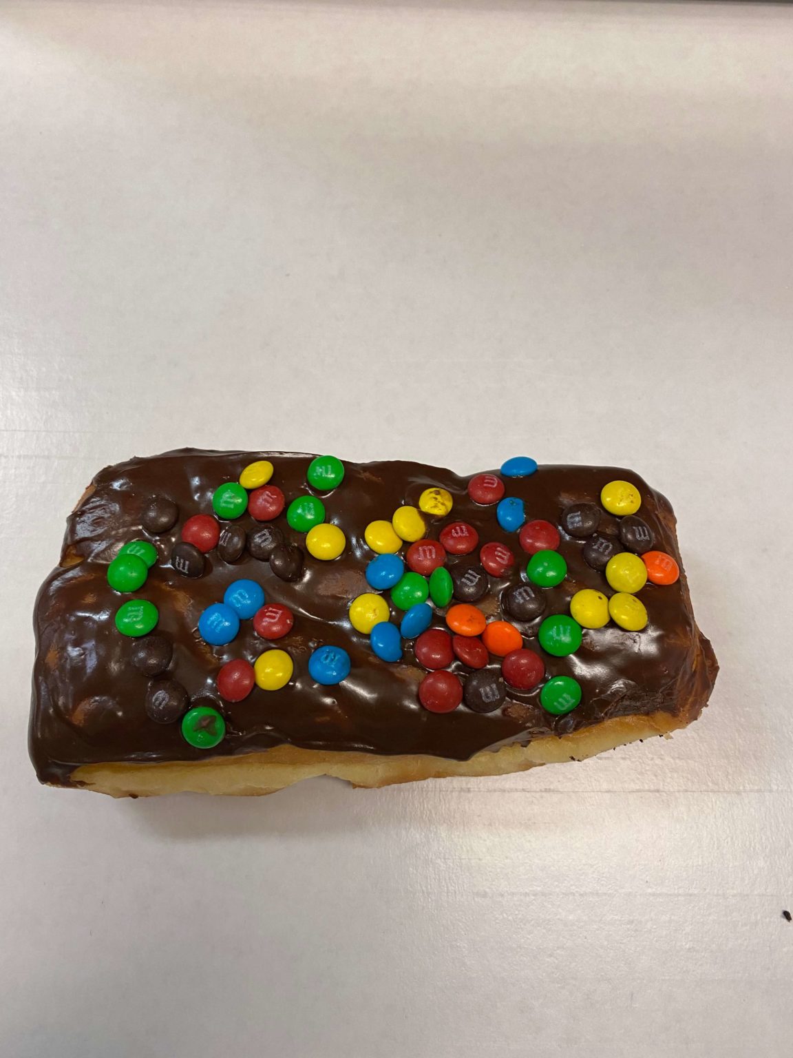 Chocolate Iced Long John with M&M’s Donut Wedding Cakes Minneapolis