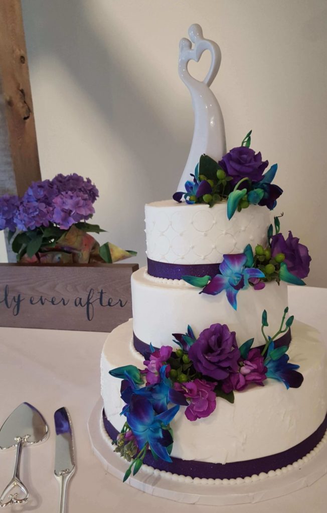 Layered Wedding Cake with Blue and Purple Flowers