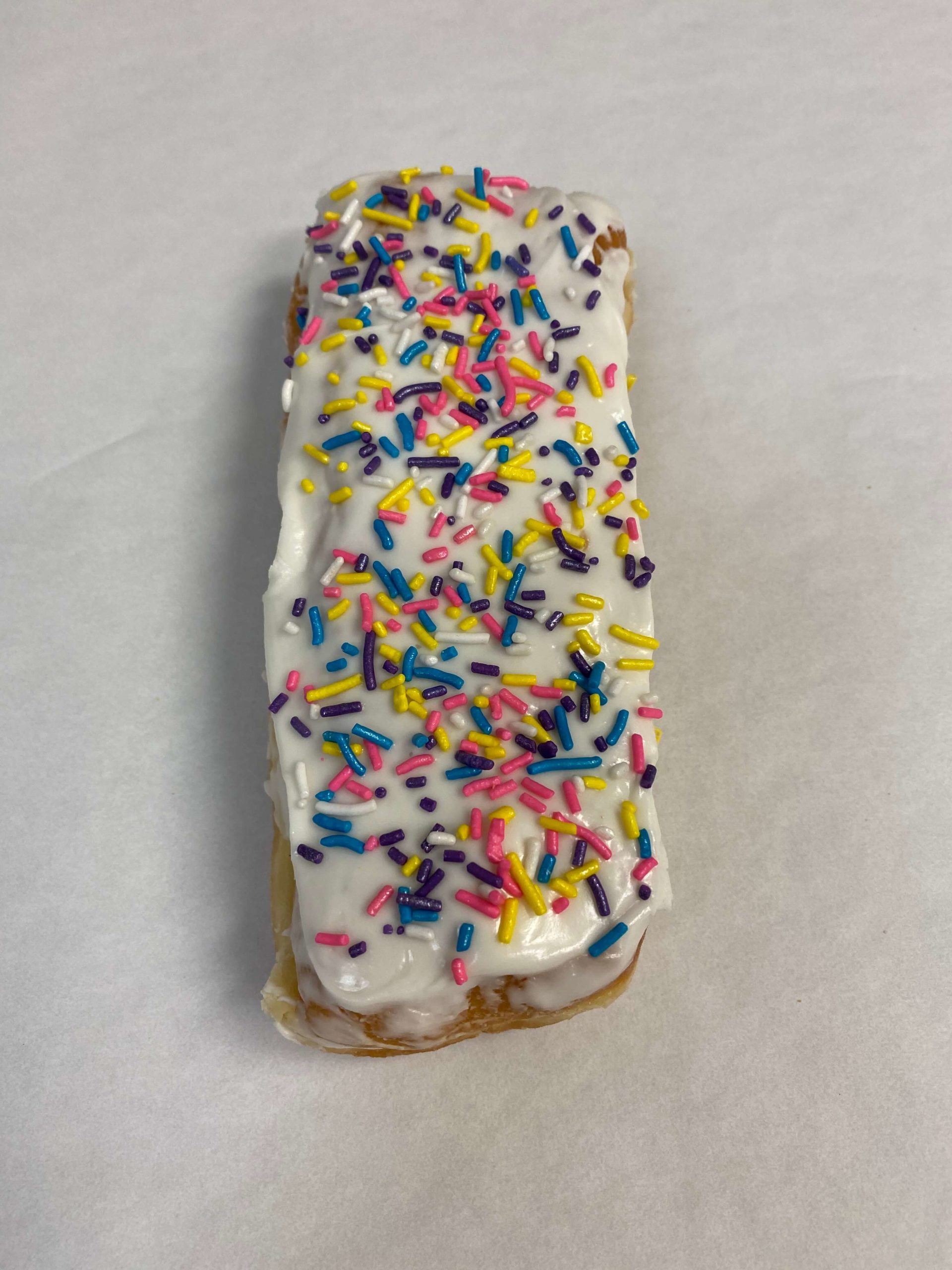 White Iced Long John with Sprinkles Donut  Wedding Cakes Minneapolis  Bakery Farmington Bakery